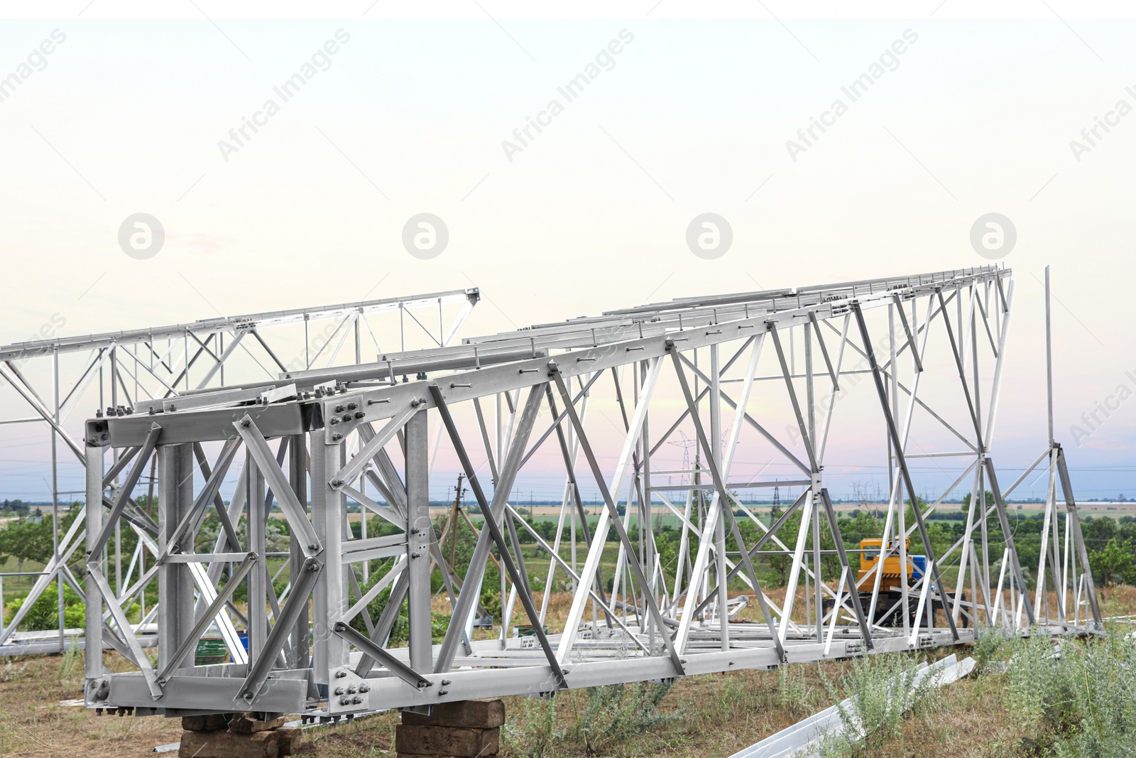 Photo of High voltage tower construction outdoors. Installation of electrical substation