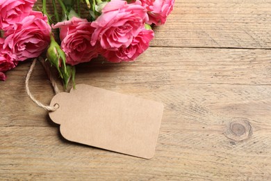 Photo of Happy Mother's Day. Beautiful flowers and blank card on wooden table, space for text