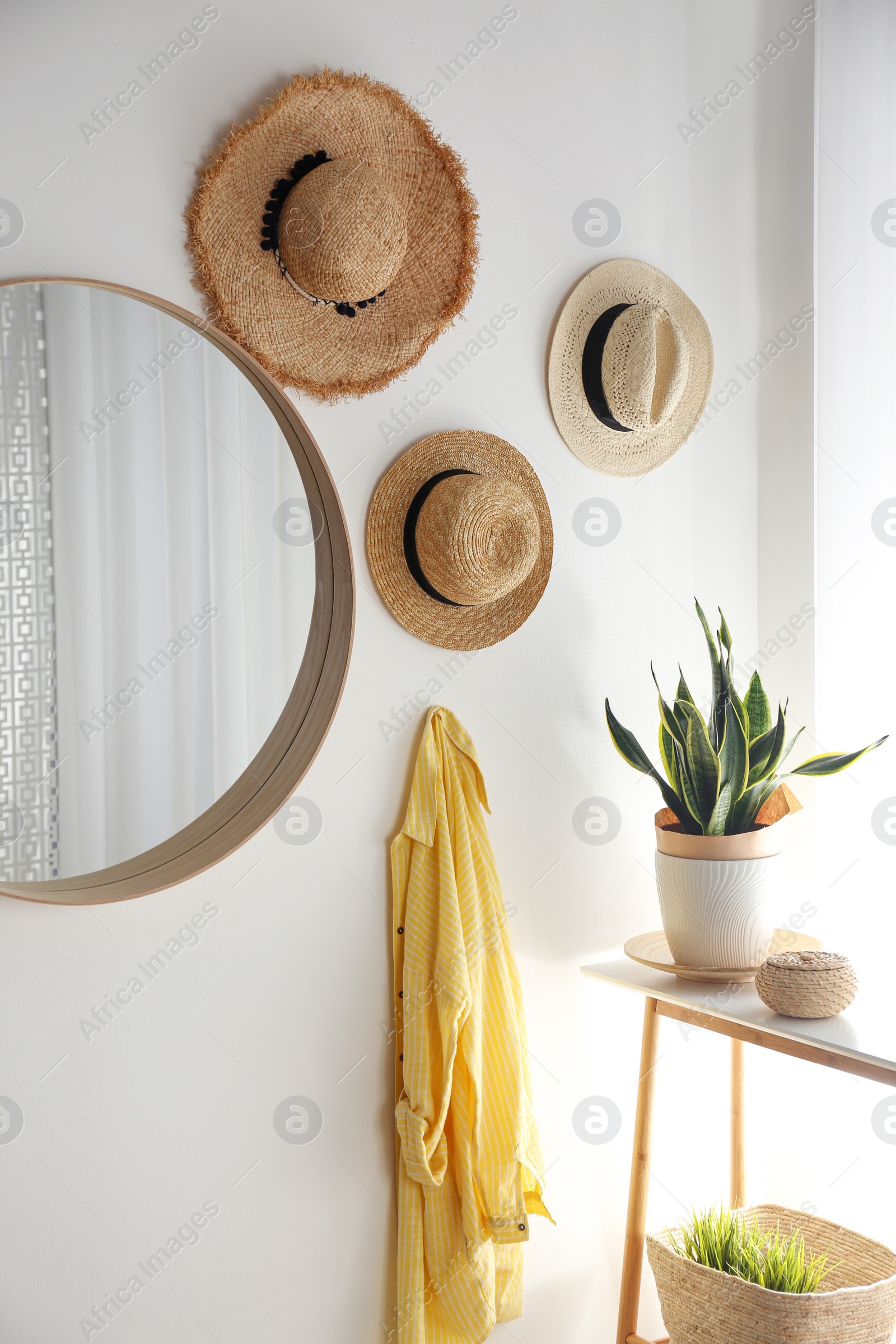 Photo of Round mirror with wooden frame on white wall in light room