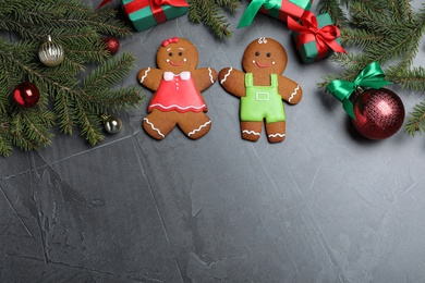 Photo of Flat lay composition with gingerbread couple on black table, space for text