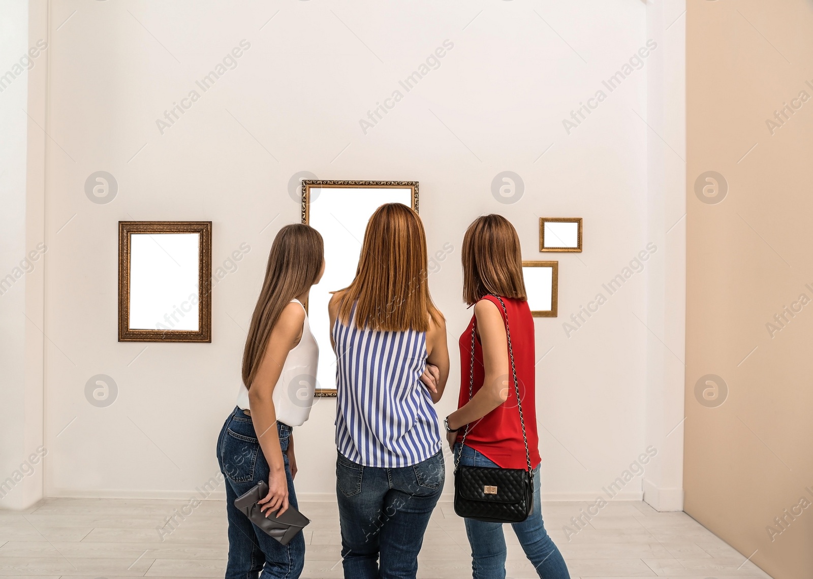 Photo of People viewing exposition in modern art gallery