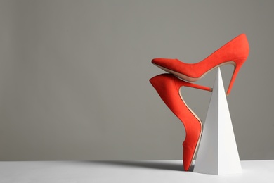 Photo of Composition with elegant female shoes on table against grey background. Space for text