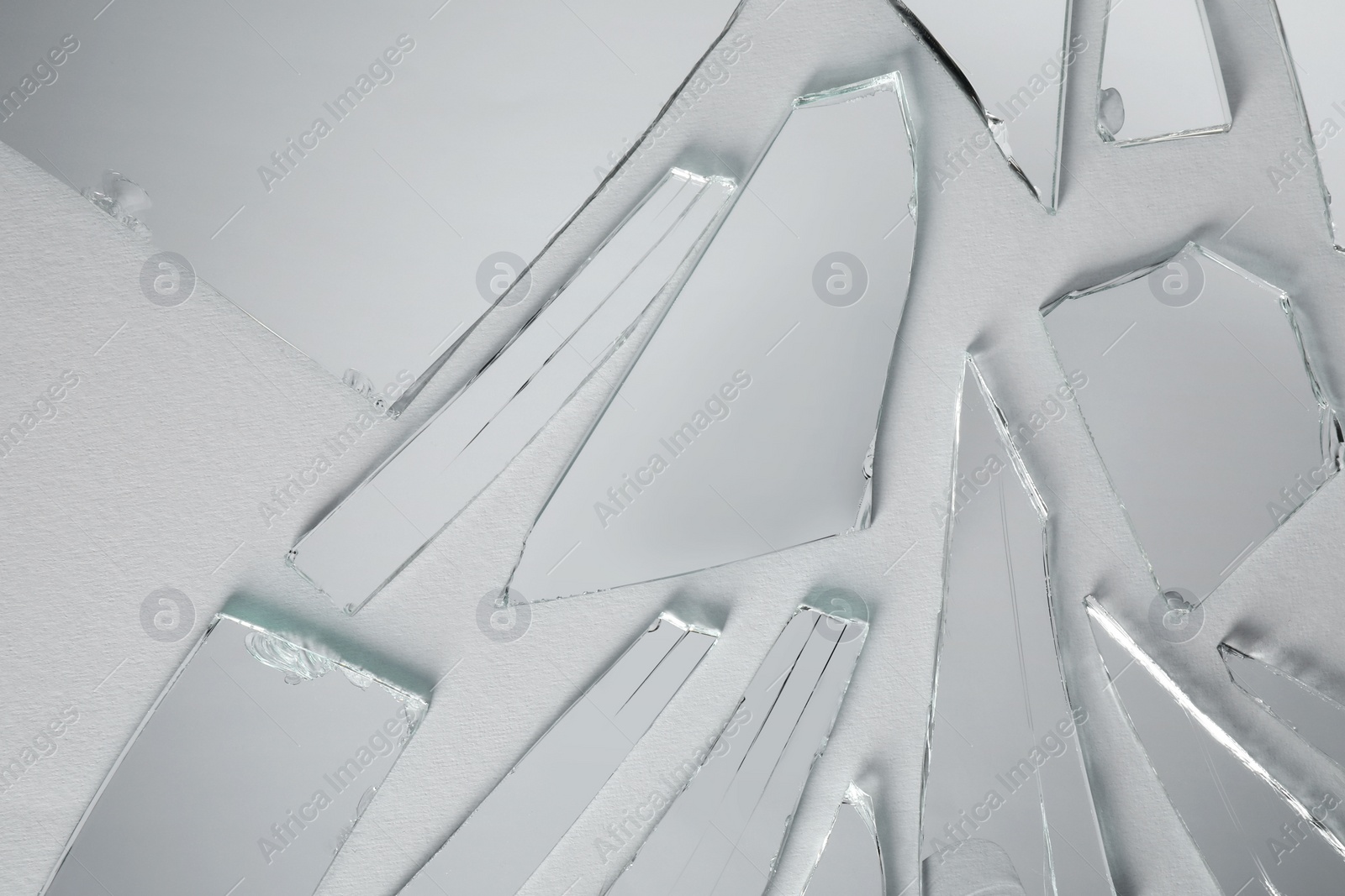 Photo of Shards of broken mirror on white background, top view