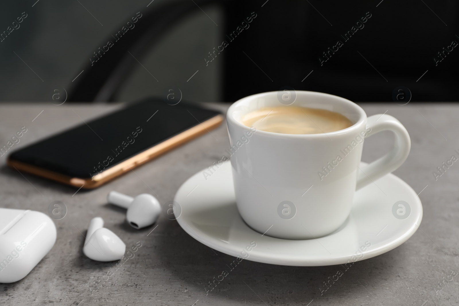 Photo of Cup of espresso on grey table in office. Coffee Break