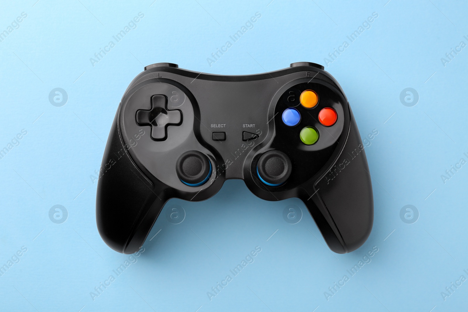 Photo of Wireless game controller on light blue background, top view