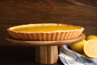 Photo of Delicious homemade lemon pie on wooden stand