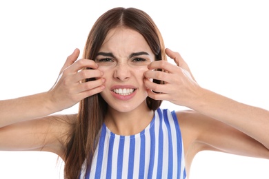 Young woman scratching face on white background. Annoying itch