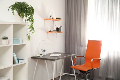 Photo of Stylish room interior with comfortable workplace near window