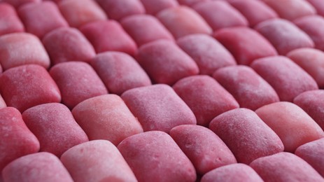 Photo of Many pink chewing gums as background, closeup