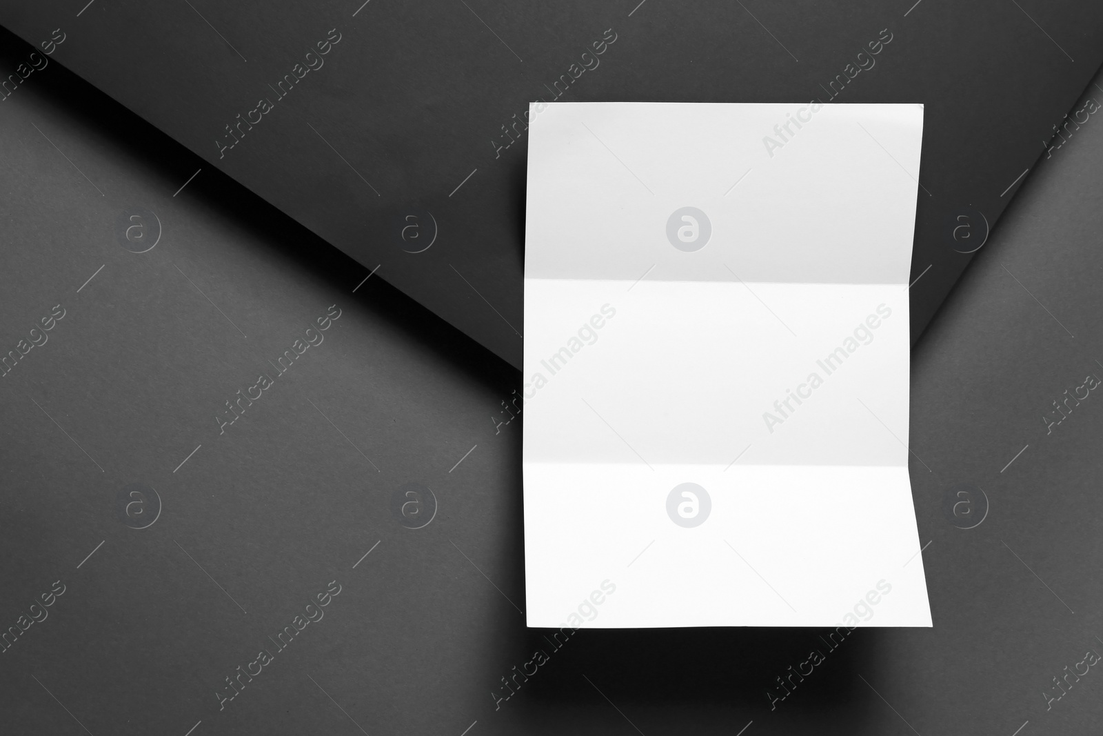 Photo of Empty flyer on dark background. Mockup for design