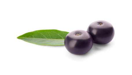 Fresh acai berries with leaf isolated on white