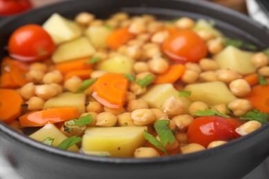 Photo of Tasty chickpea soup in bowl, closeup view