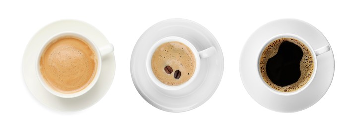 Set of cups with aromatic hot coffee on white background, top view. Banner design