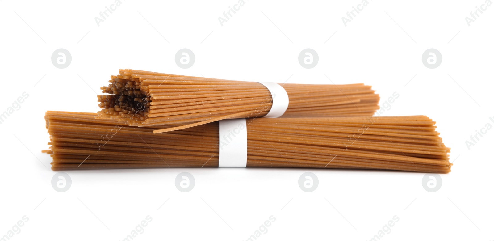 Photo of Uncooked buckwheat noodles isolated on white. Japanese cuisine