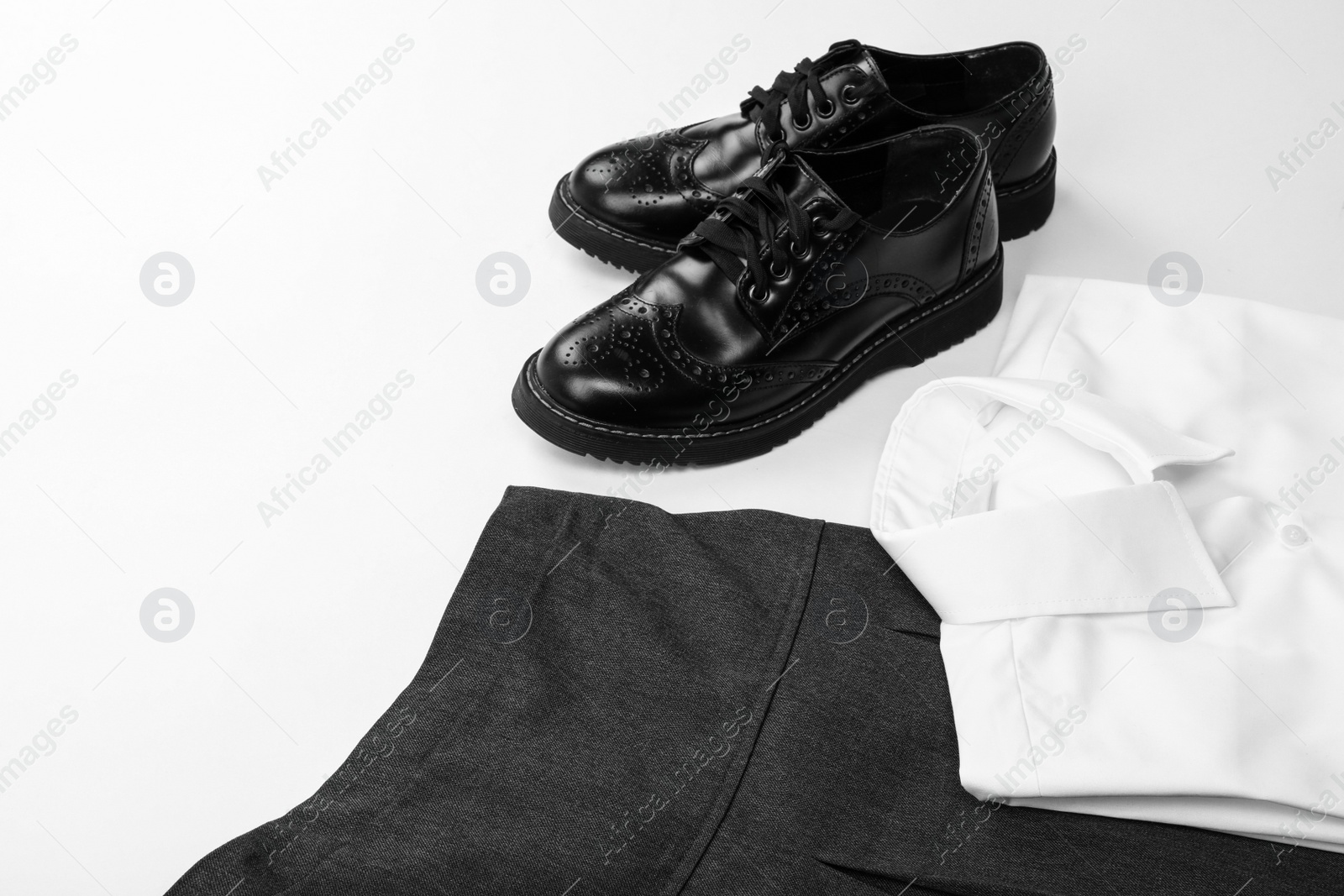 Photo of New stylish school uniform on white background, closeup