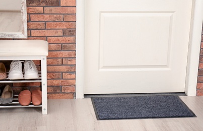 Photo of Hallway interior with shoe rack and mat near door