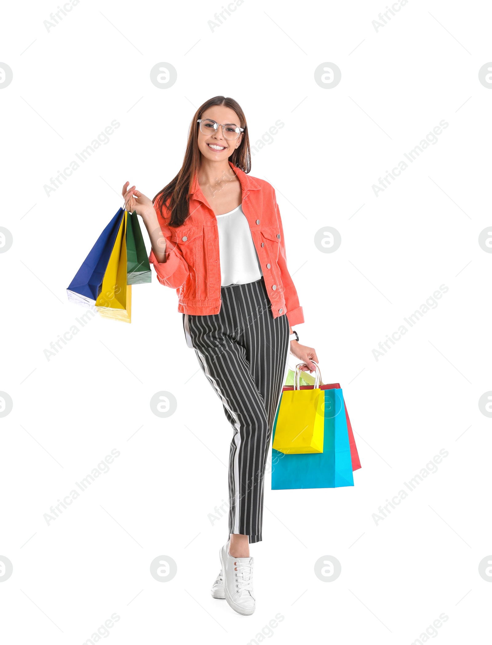 Photo of Young woman with shopping bags on white background