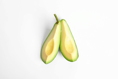 Slices of avocado on white background