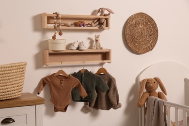 Photo of Nursery interior with stylish furniture, clothes and accessories