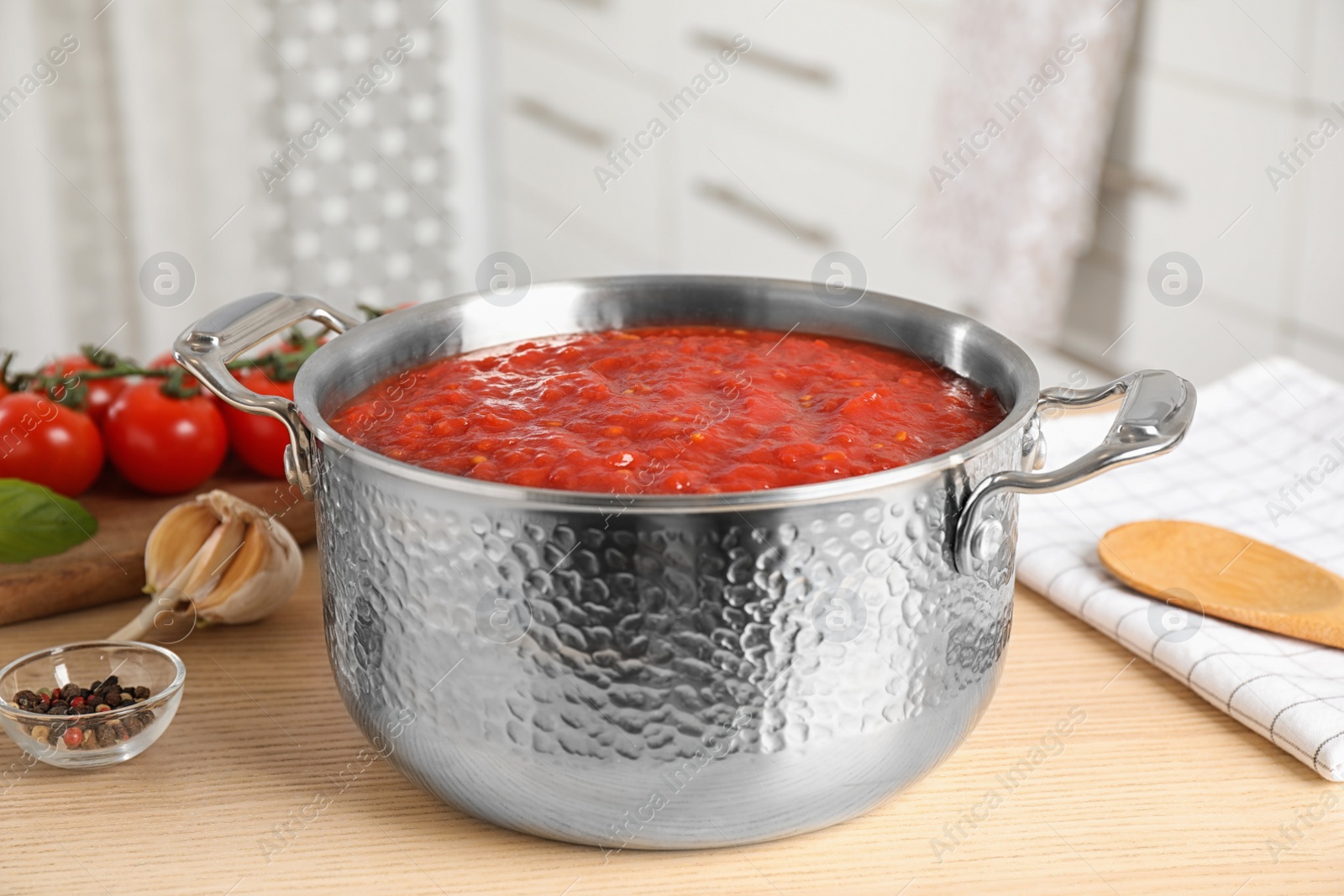 Photo of Fresh delicious tomato sauce on wooden table