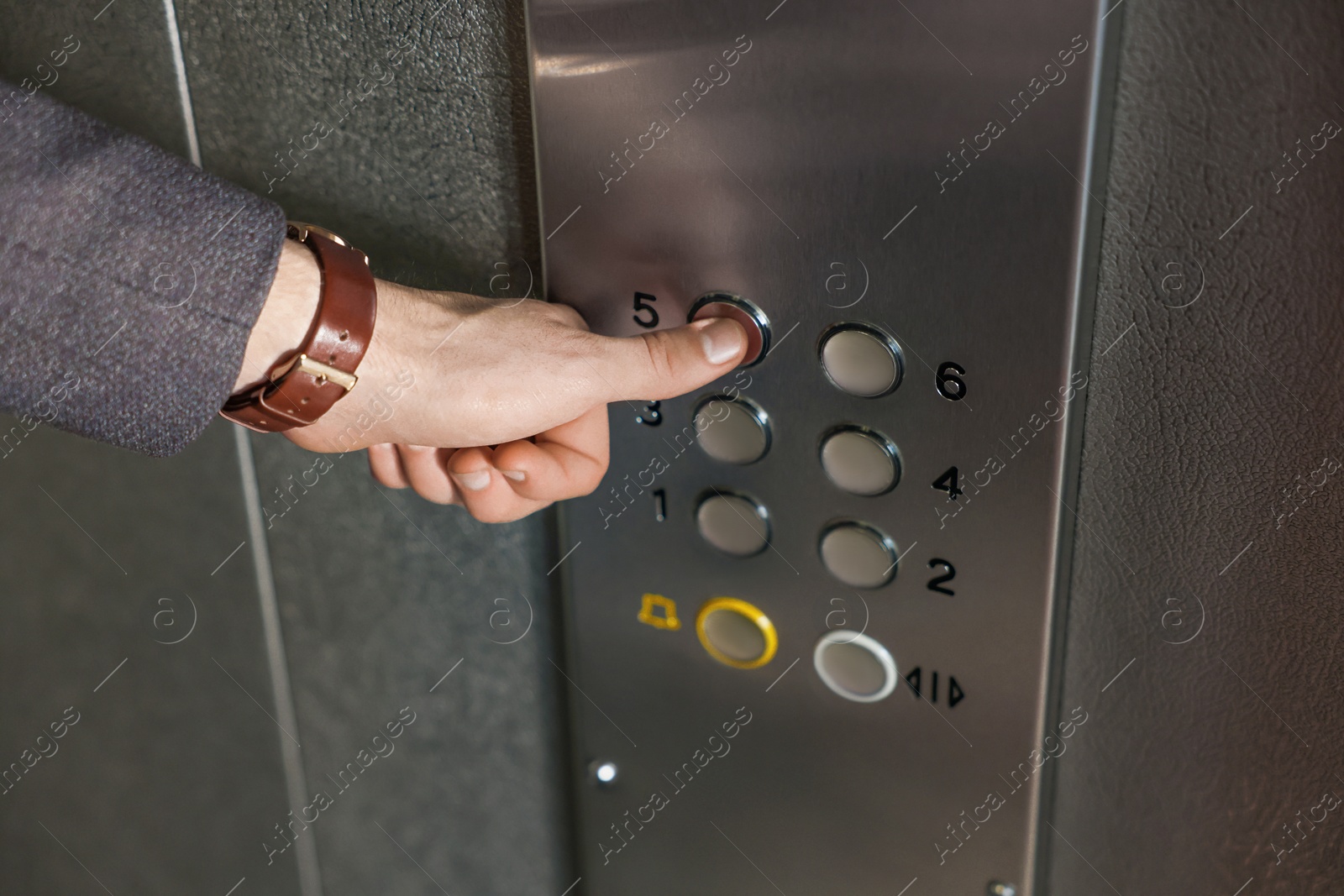 Photo of Man choosing floor in elevator, closeup view