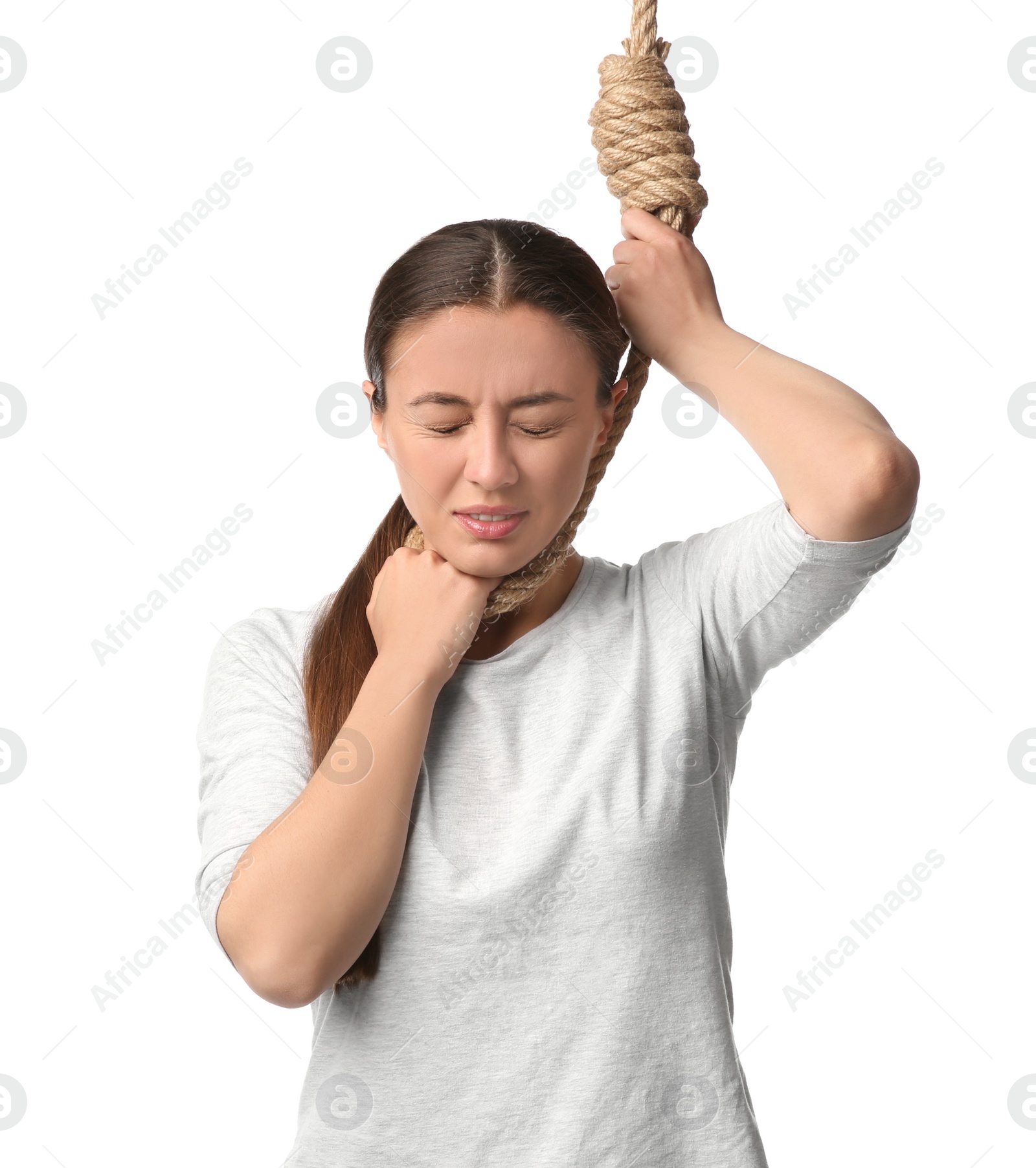 Photo of Depressed woman with rope noose on neck against white background