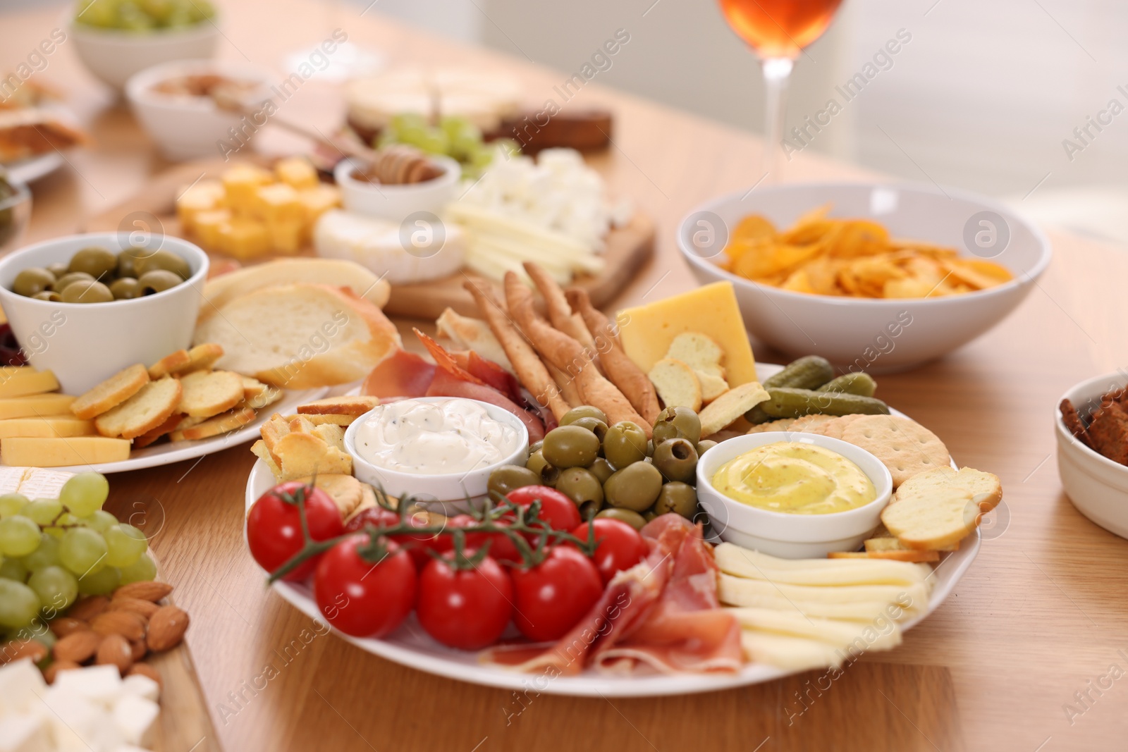 Photo of Assorted appetizers served on wooden table, closeup