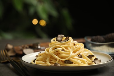 Photo of Tasty fettuccine with truffle on table, closeup