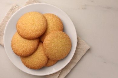 Photo of Delicious Danish butter cookies on white marble table, top view. Space for text