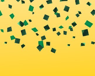 Shiny green confetti falling on yellow background