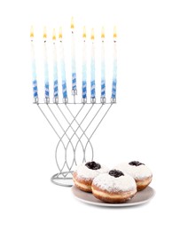Photo of Hanukkah celebration. Menorah with candles and donuts isolated on white
