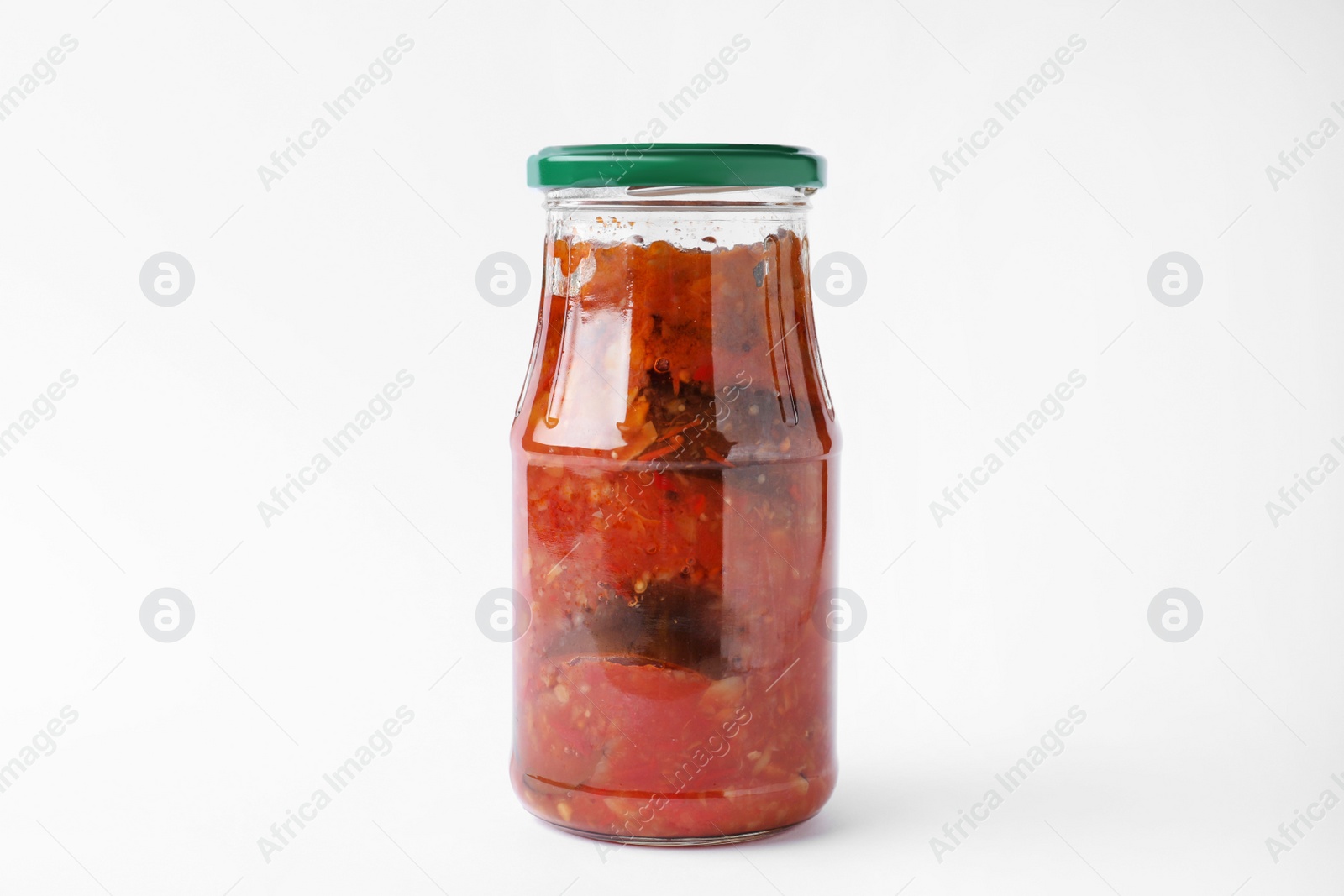 Photo of Jar with tasty vegetable sauce on white background. Pickled food