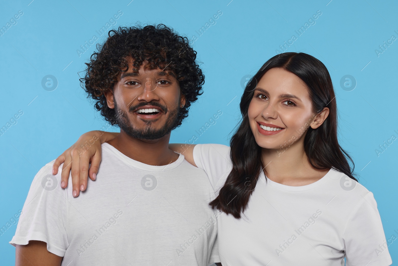 Photo of International dating. Portrait of happy couple on light blue background