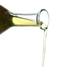 Pouring fresh olive oil on white background