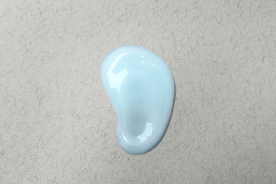 Photo of Sample of hand cream on light gray background, top view