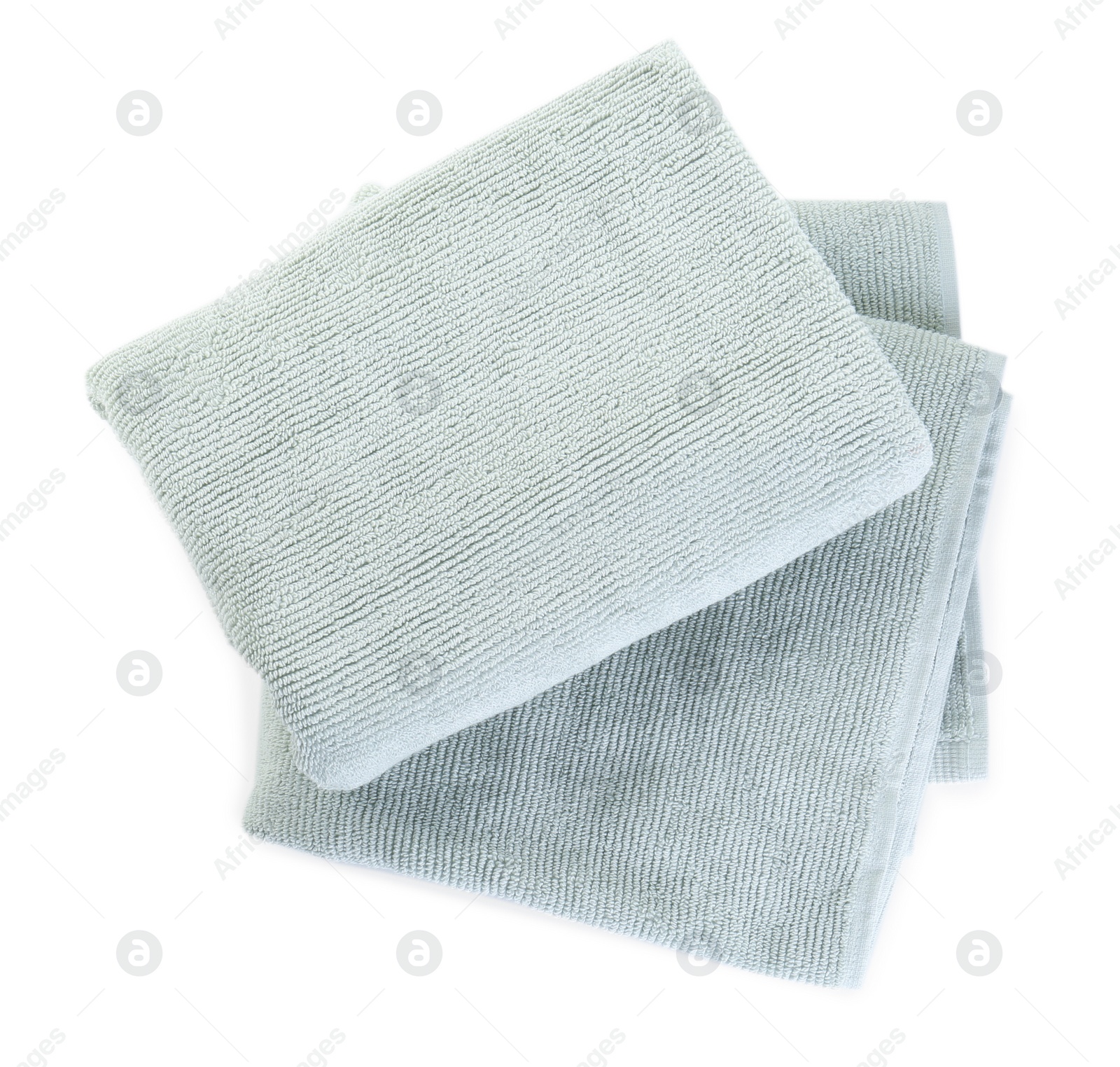 Photo of Soft folded towels isolated on white, top view