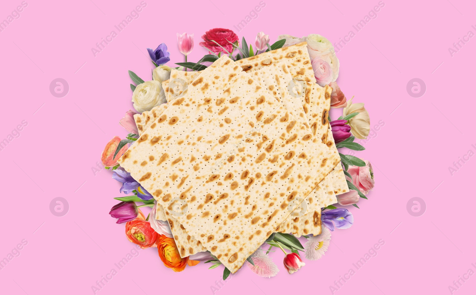 Image of Tasty matzos and flowers on pink background, flat lay. Passover (Pesach) celebration