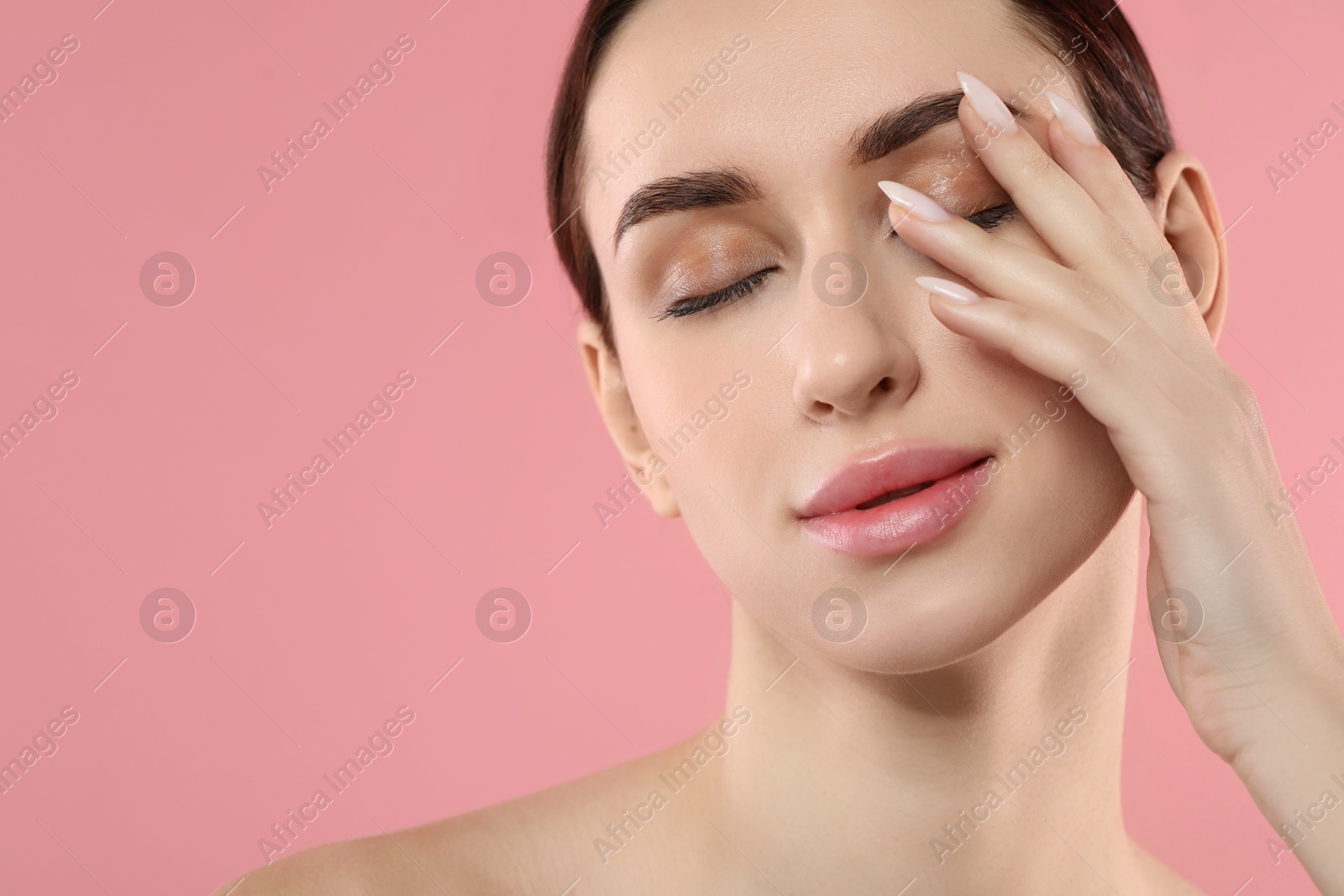 Photo of Beautiful young woman with healthy skin on pink background, closeup. Space for text