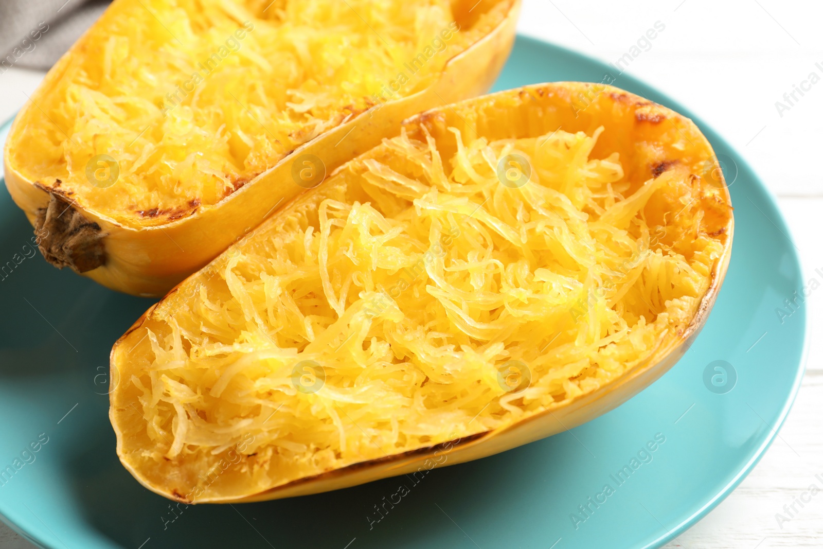 Photo of Plate with cooked spaghetti squash on white background, closeup