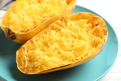 Plate with cooked spaghetti squash on white background, closeup