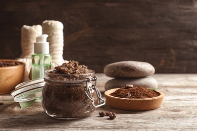 Photo of Handmade natural body scrub and coffee on wooden table