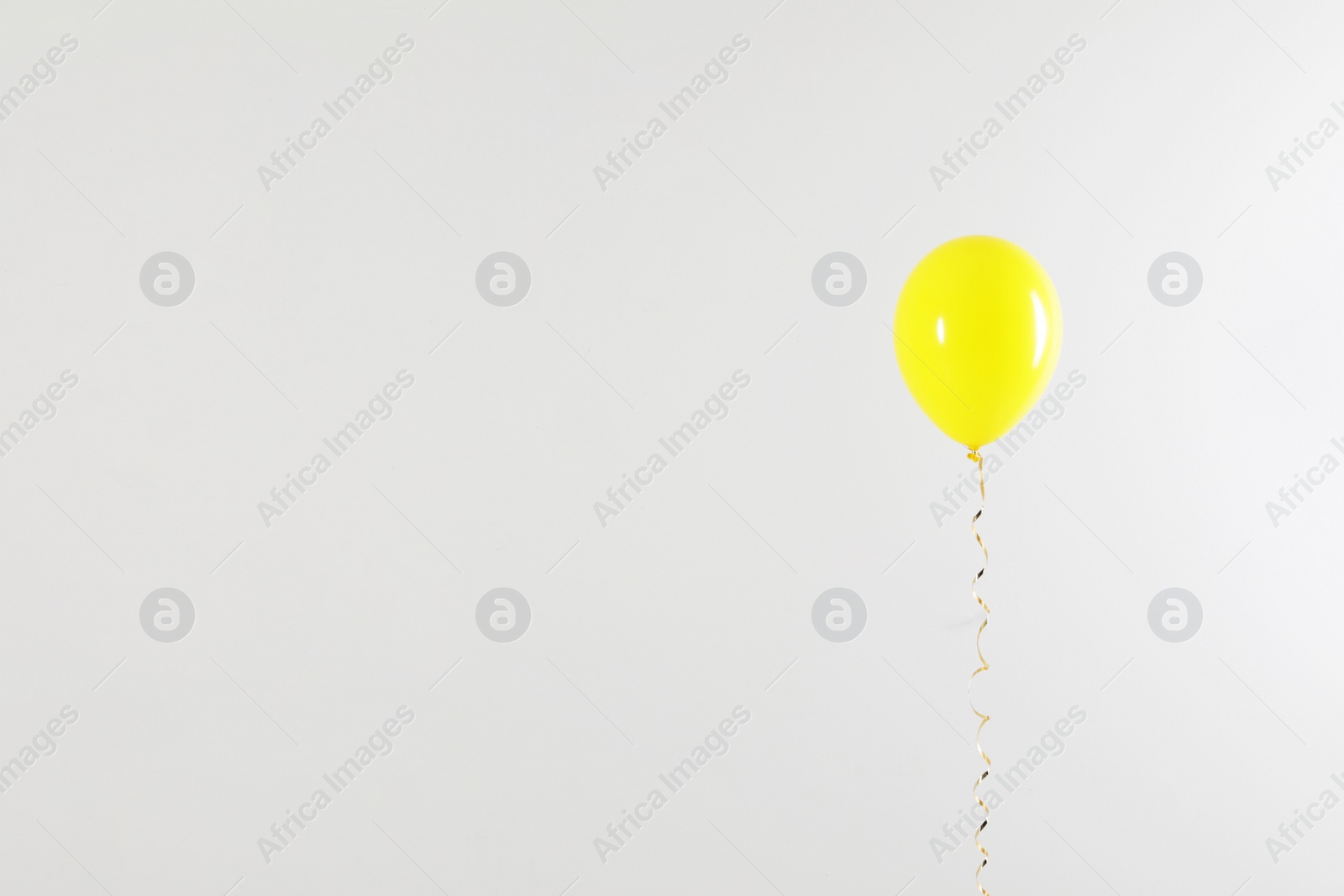 Photo of Bright balloon on light background, space for text. Celebration time