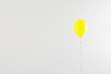 Photo of Bright balloon on light background, space for text. Celebration time