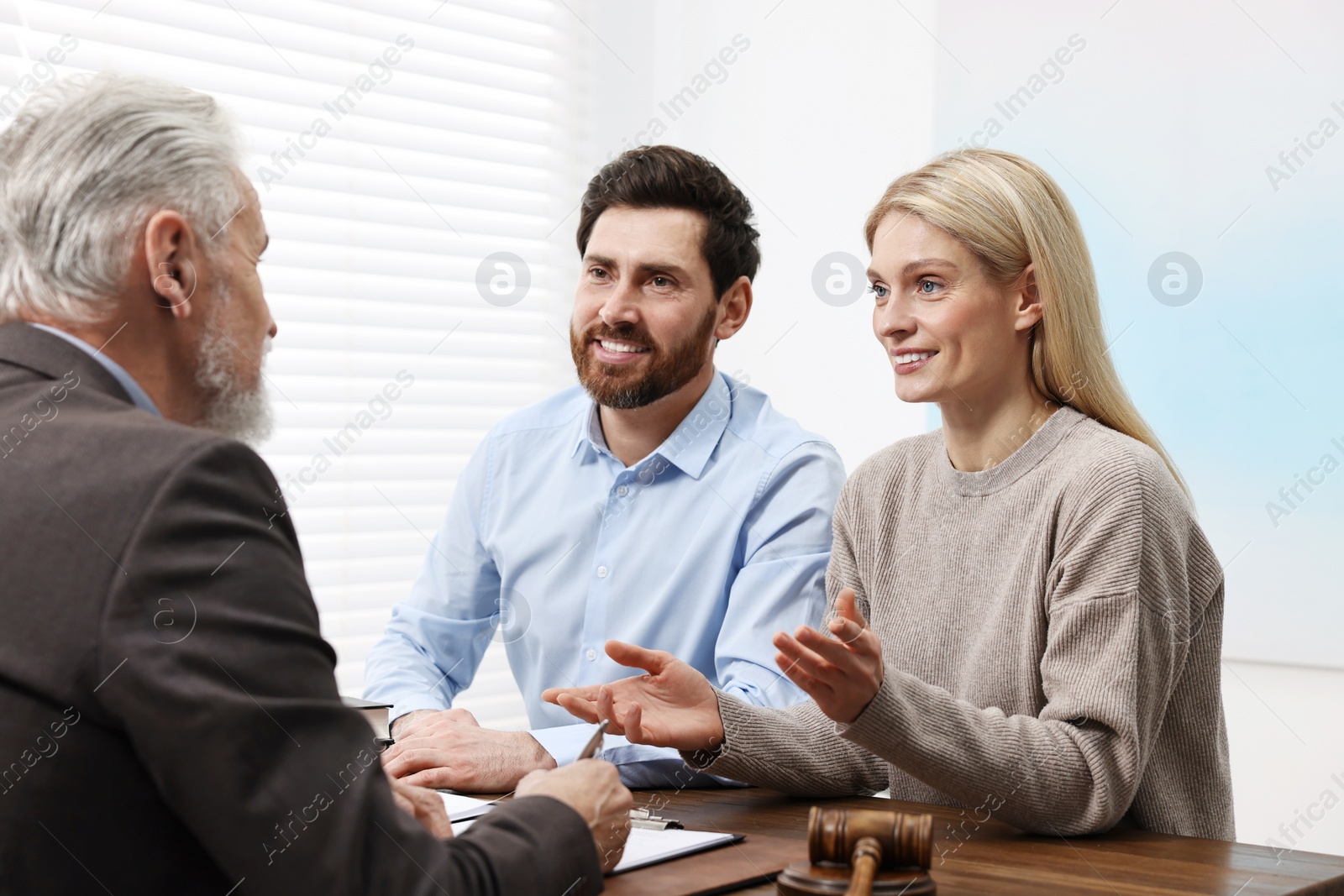 Photo of Couple having meeting with lawyer in office