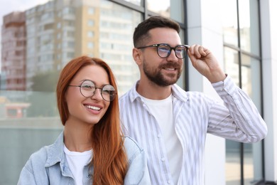 Photo of Portrait of happy couple in glasses outdoors