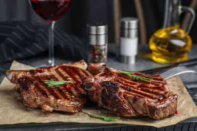 Photo of Delicious beef steaks served on table, closeup