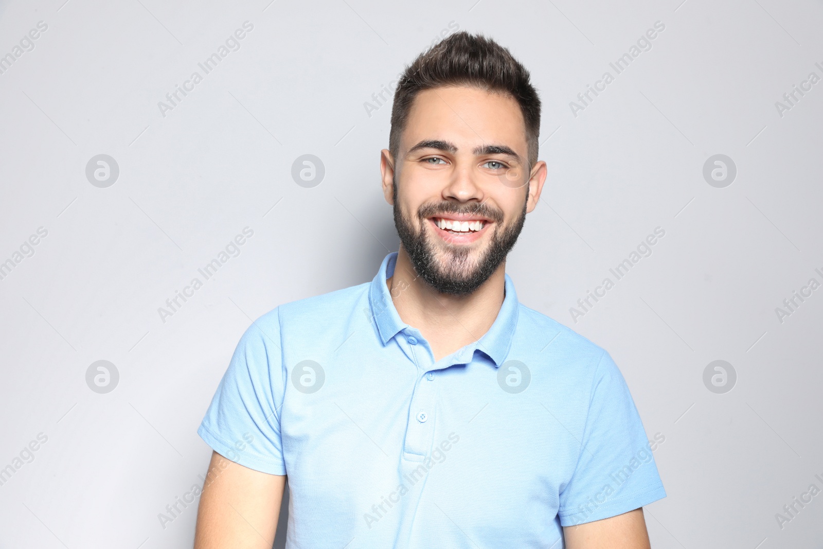 Photo of Portrait of handsome young man against light background