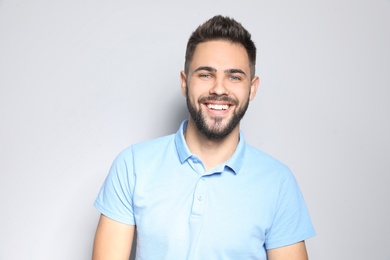 Photo of Portrait of handsome young man against light background