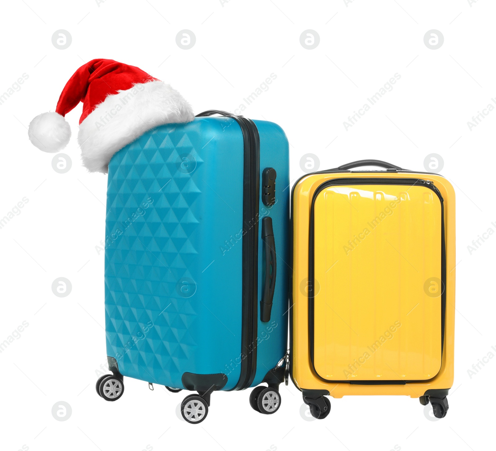 Image of Stylish suitcases with Santa Claus hat on white background. Christmas vacation 