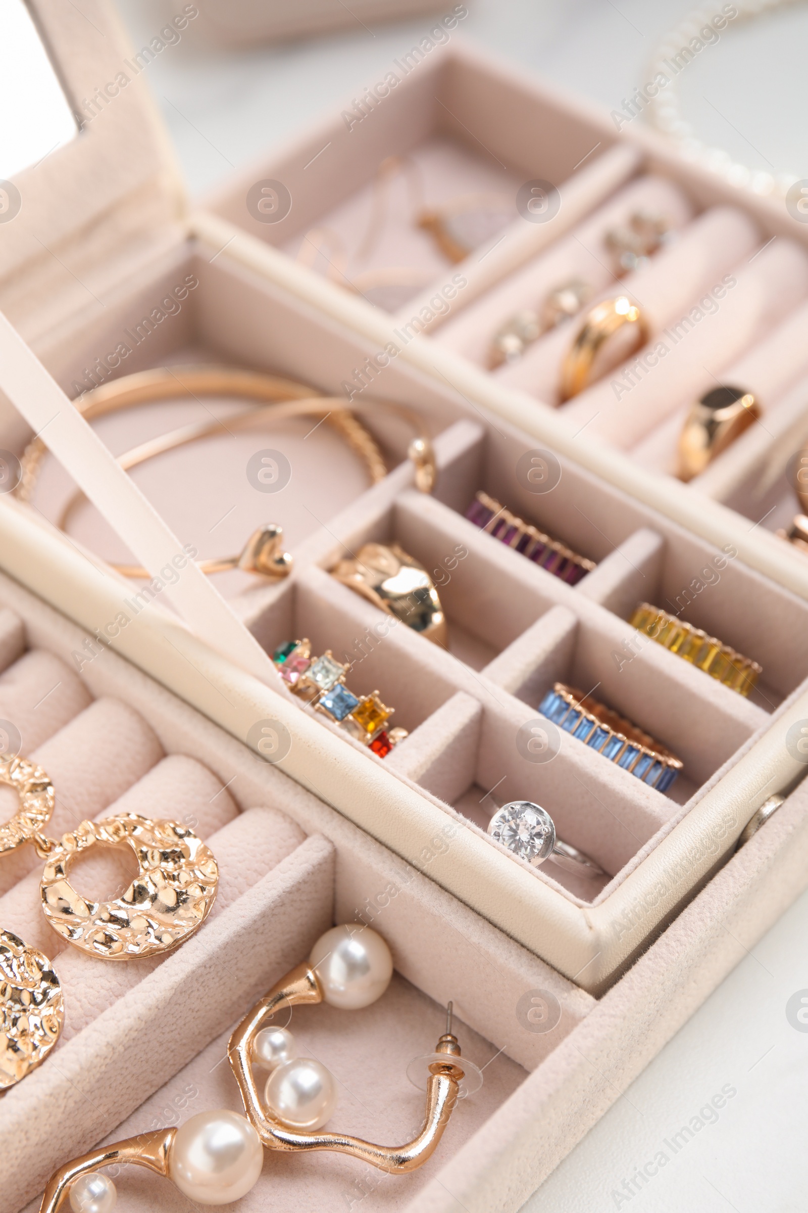 Photo of Jewelry box with stylish golden bijouterie on white table